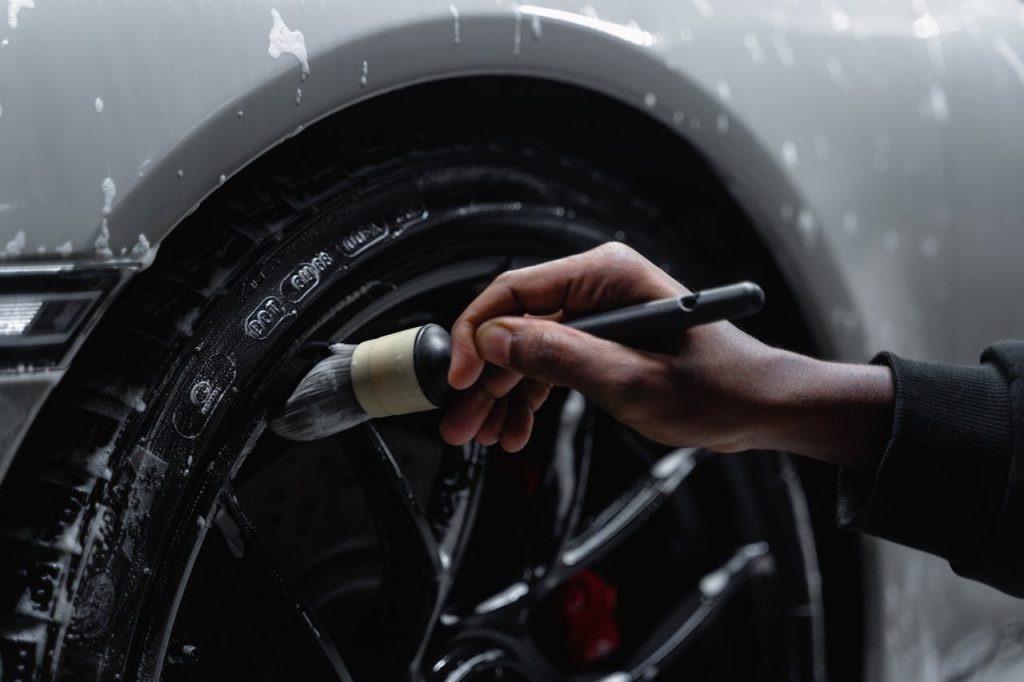 a mechanic brushes a car tire