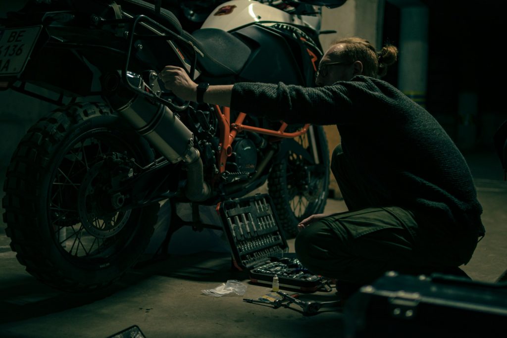 mechanic repairing a salvage motorcycle