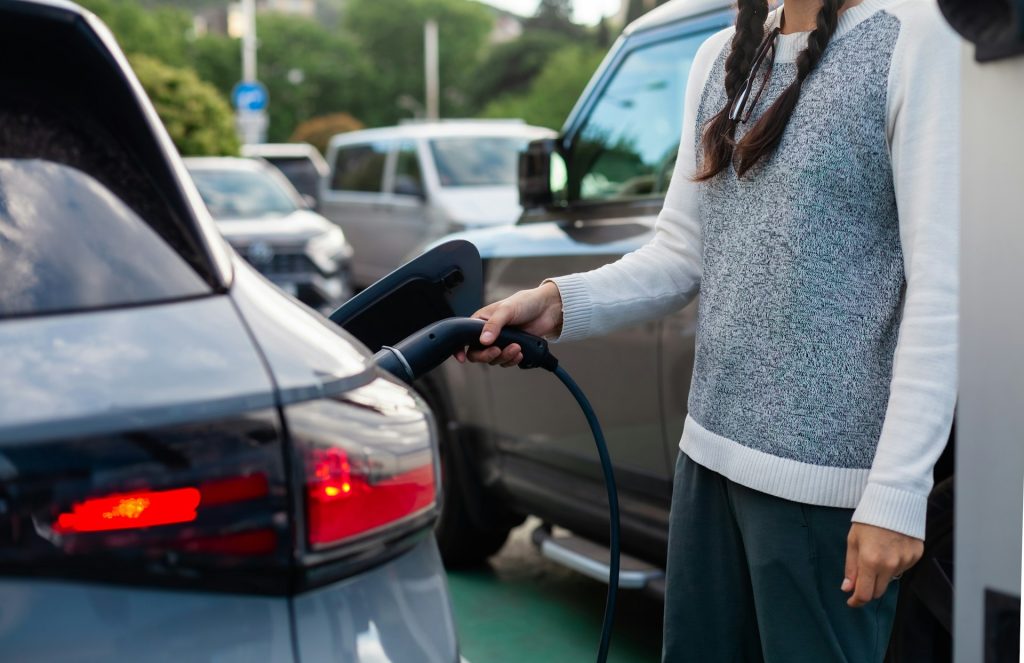 woman charging her electric car