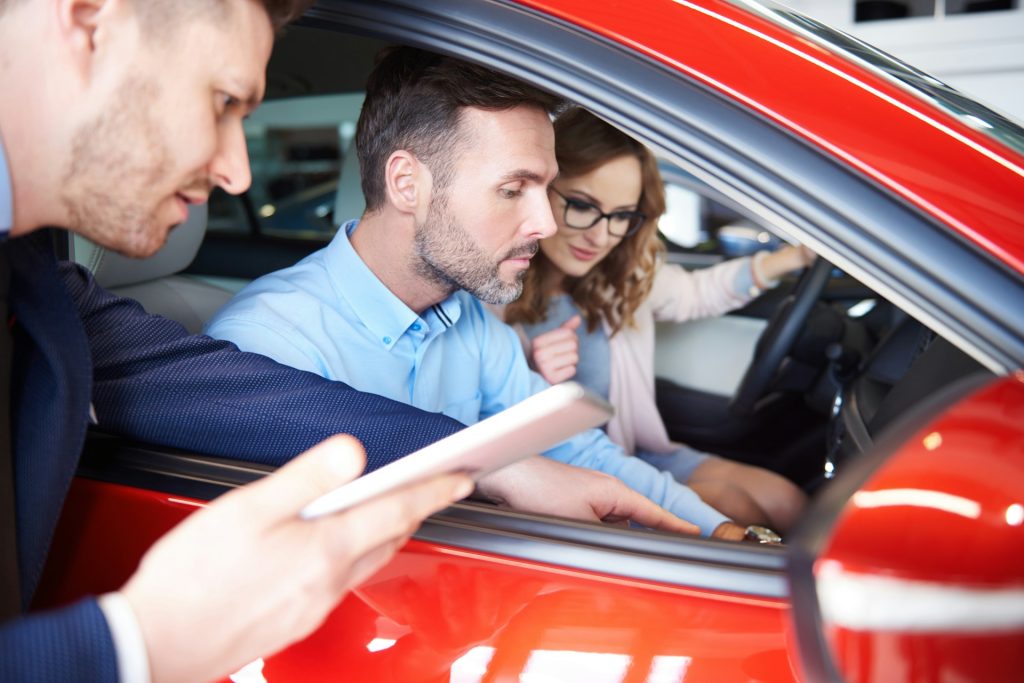 buyers at a car dealership