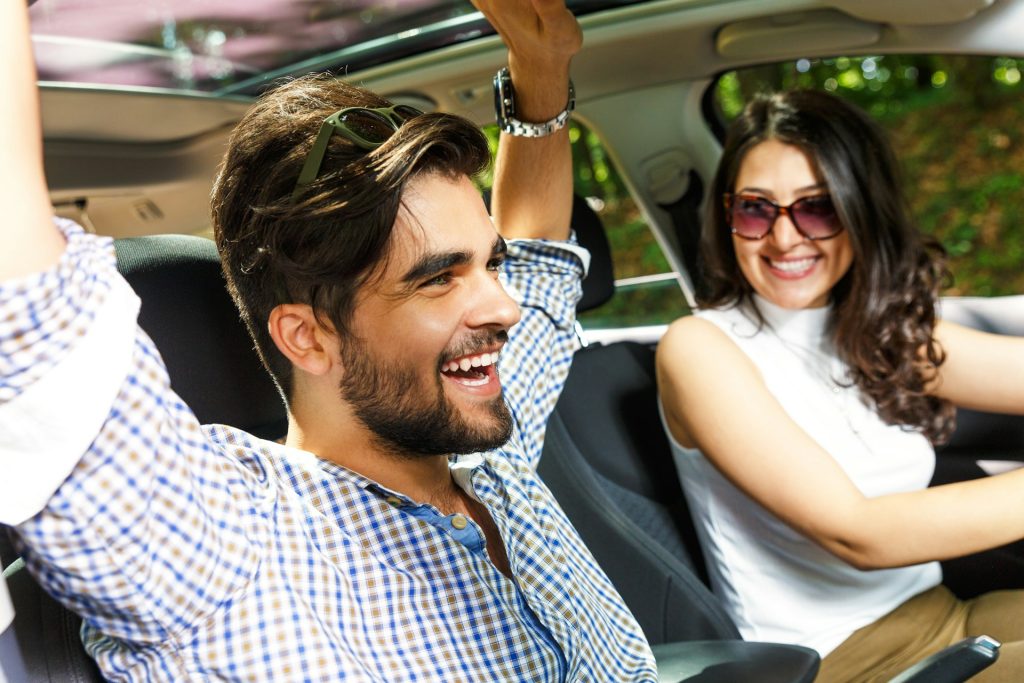 happy couple in a family car
