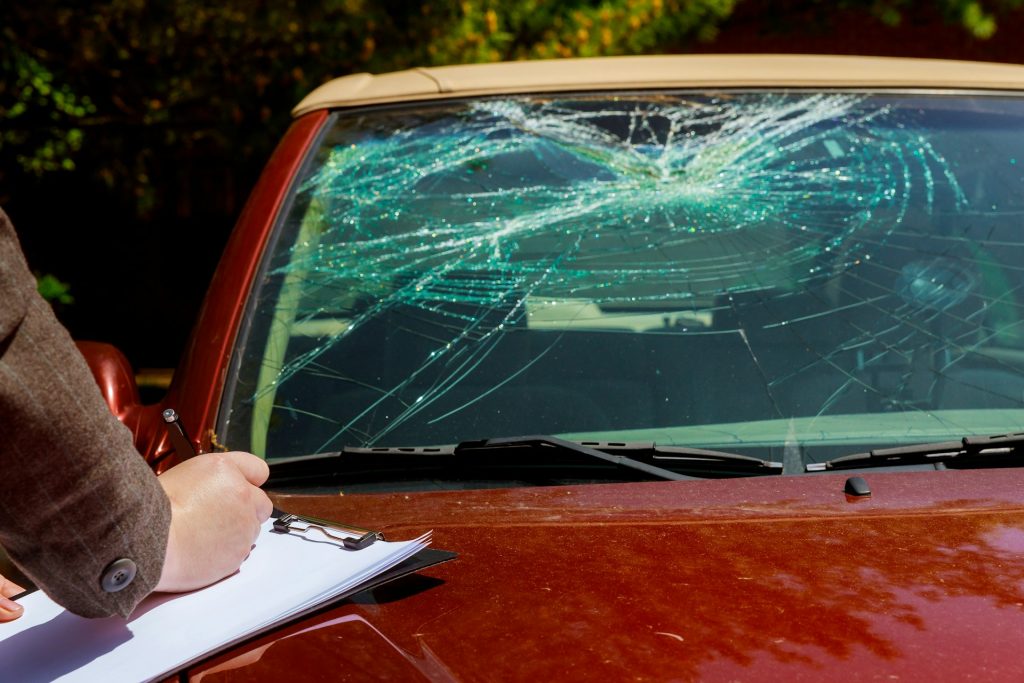 checking a car with a damaged windshield
