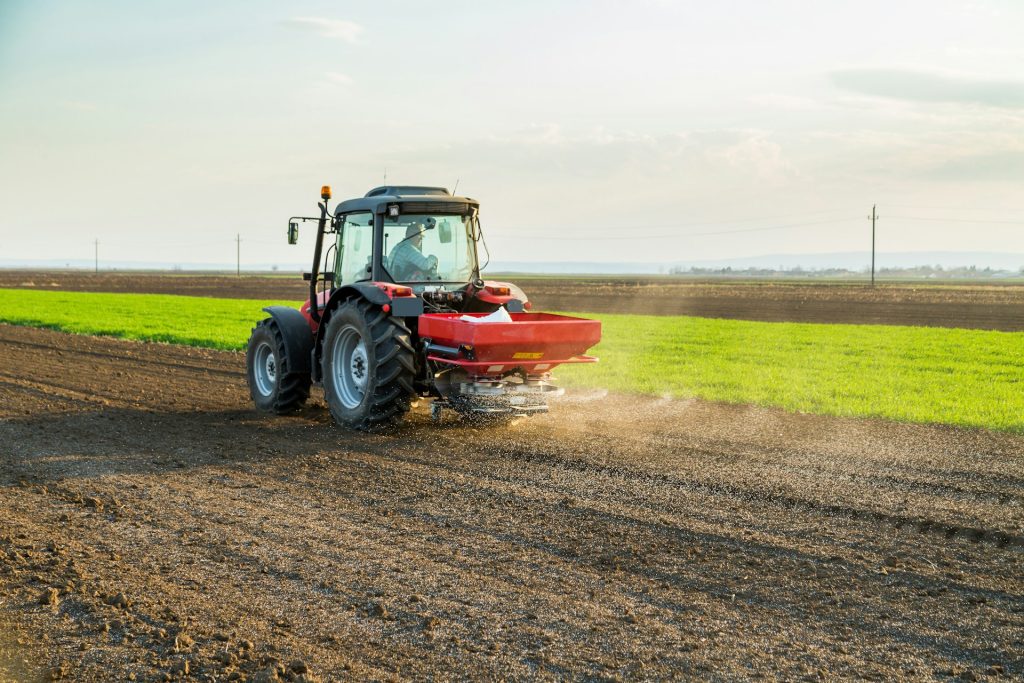 a farmer works in a tractor in the summer in the field