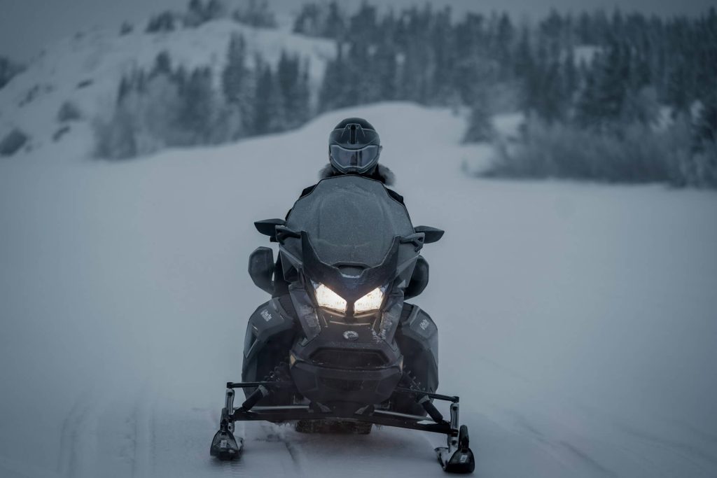 a man driving a snowmobile