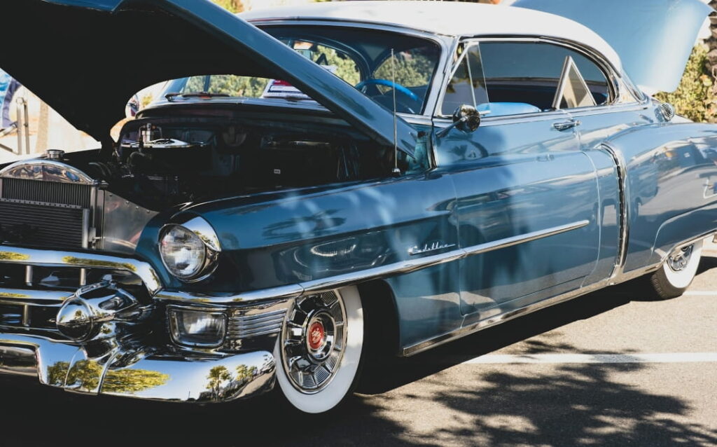 classic Cadillac with open hood displayed at a car auction